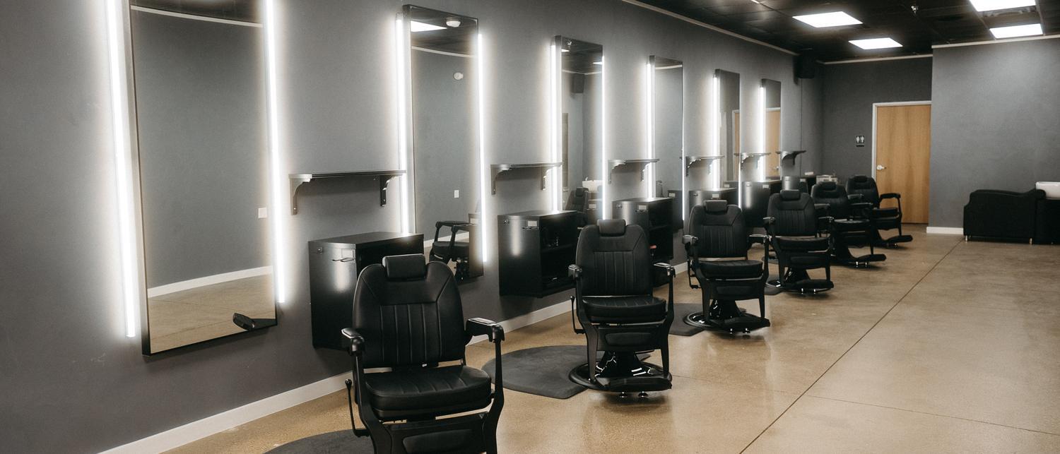 The floor at Stone Barber, Southlake TX — barber chairs and lit mirrors